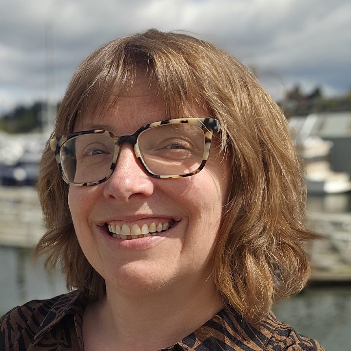Kate Chapman smiling at a marina on a sunny day